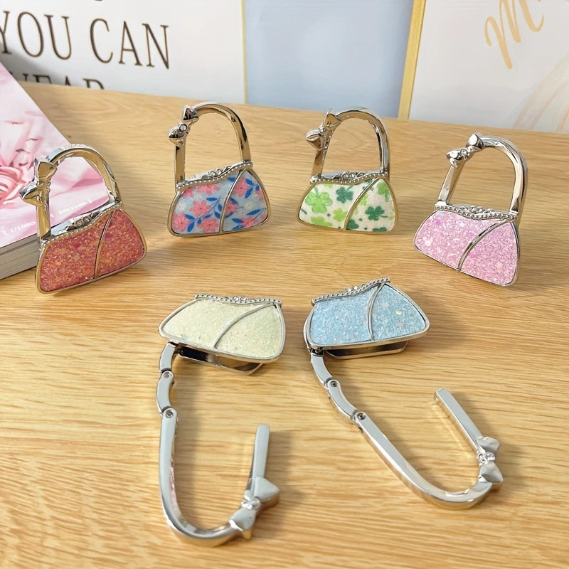 Cuelga Bolsos Plegable para Mesa – "Gema de Hi'ilawe" 👜✨💎